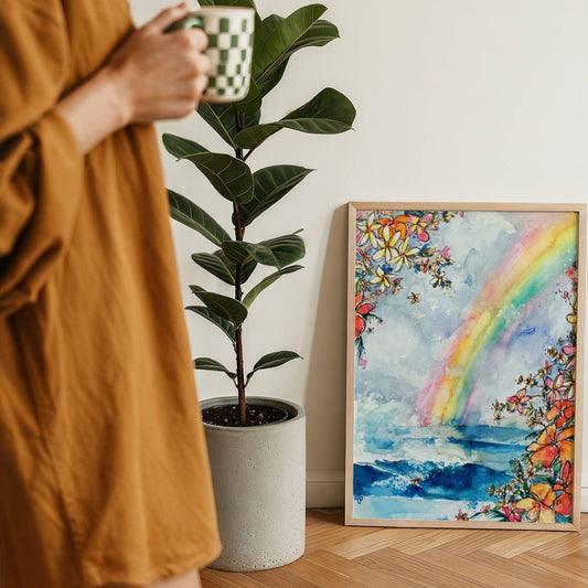 Wave Under the Rainbow watercolour surf art print by Rebekah Steen framed and leaning on the floor