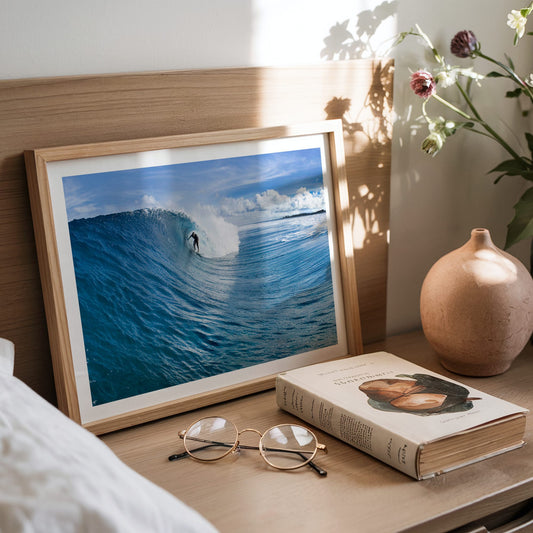 Blue Sling surf photography print with a white border by Sean Davey framed and leaning on a bedside table