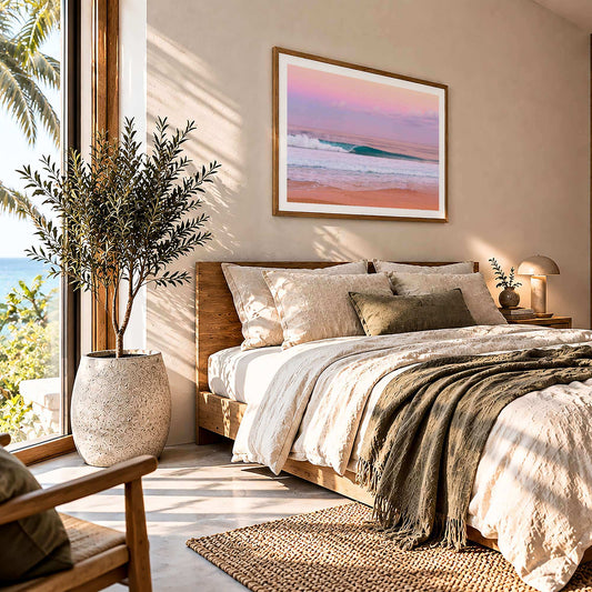 Pink Pipe surf photography print with a white border by Sean Davey framed above a bed beside a window