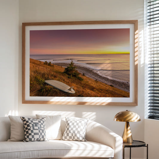 Rolling Lines surf photography print by Adam Cornick framed above a white sofa