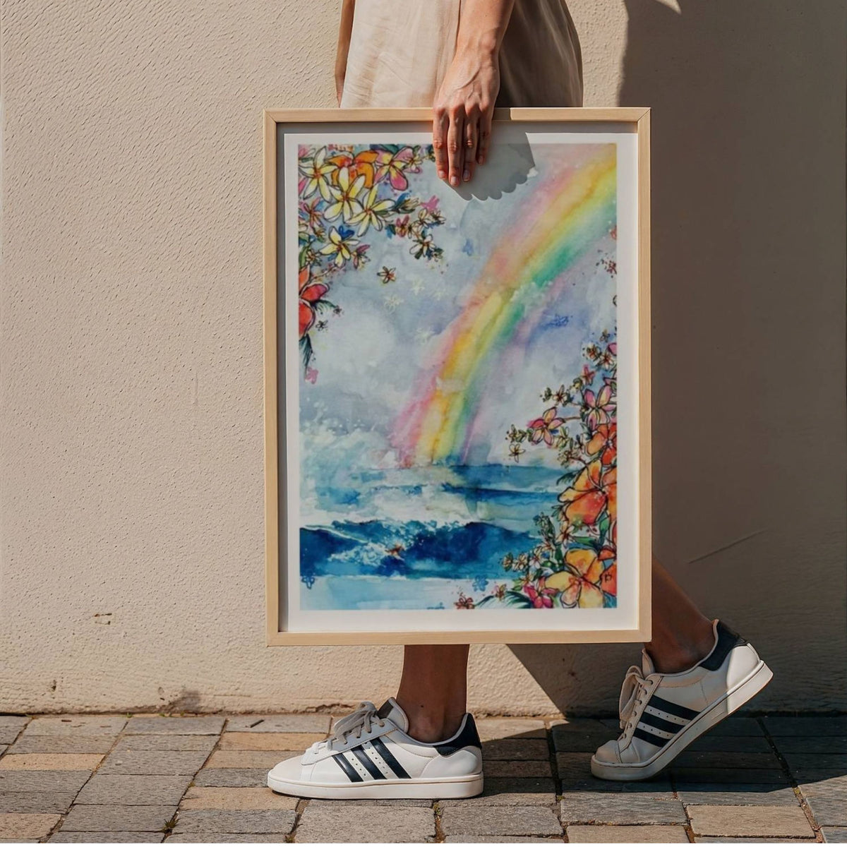 Framed Wave Under the Rainbow surf art print by Rebekah Steen held in hand