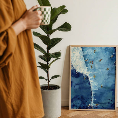 Above The Set watercolour surf art print by Rebekah Steen displayed beside a coffee