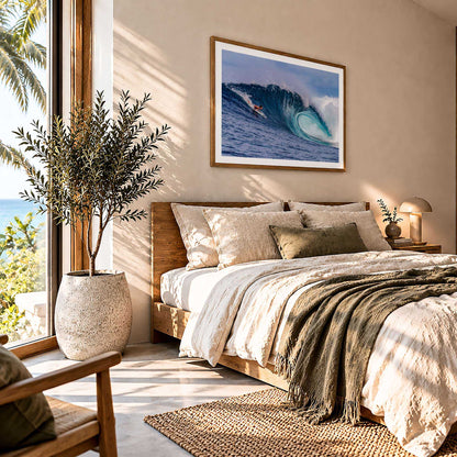 Almond Tubes surf photography print by John Seaton Callahan with a white border, framed above a bed beside a window
