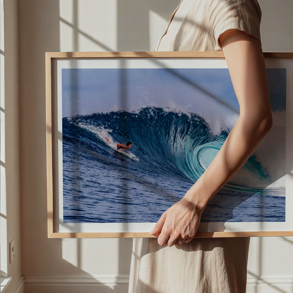 Almond Tubes surf photography print by John Seaton Callahan with a white border, being carried in a natural wood frame
