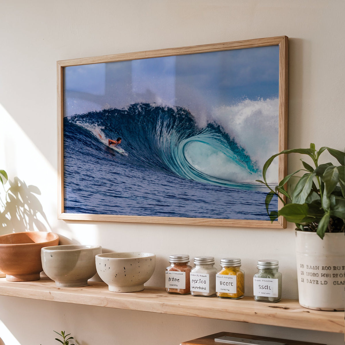 Almond Tubes surf photography print by John Seaton Callahan framed above a kitchen shelf with spice jars