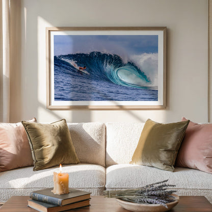 Almond Tubes surf photography print by John Seaton Callahan with a white border, framed above a sofa with cushions