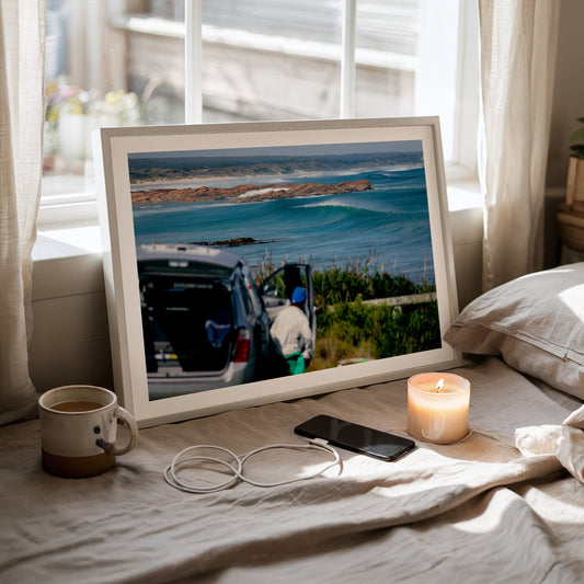 Beachbreak Perfection, Tasmania surf photography print with a white border by Sean Davey framed and leaning on a bed