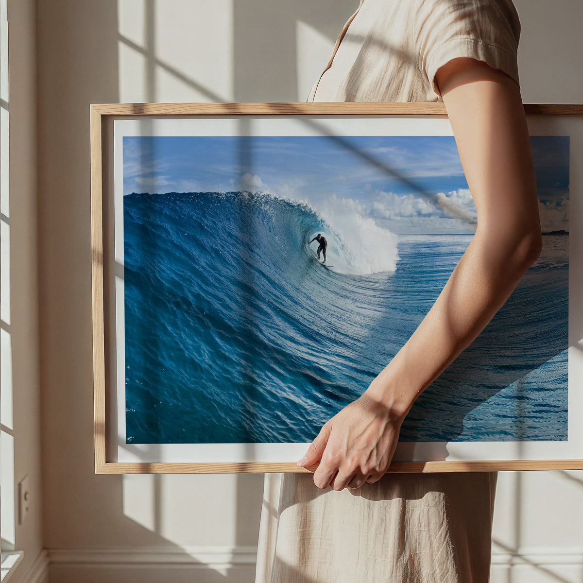 Blue Sling surf photography print with a white border by Sean Davey being carried in a natural wood frame