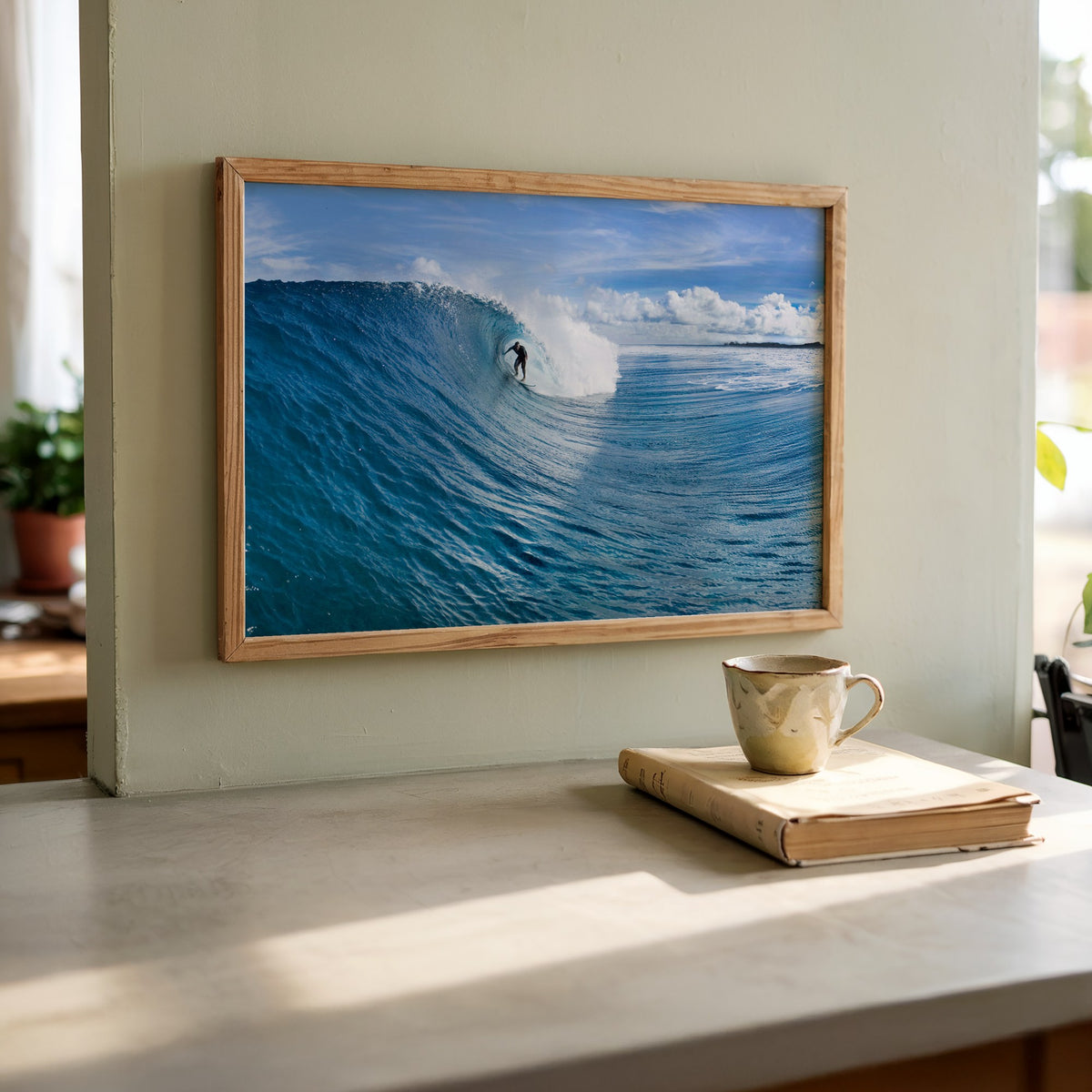 Blue Sling surf photography print by Sean Davey framed and leaning on a kitchen counter beside a mug