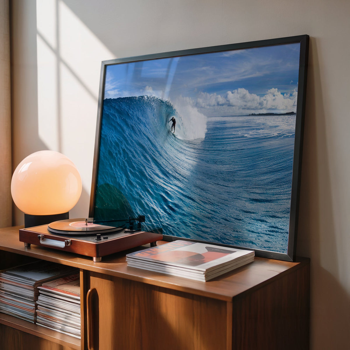 Blue Sling surf photography print by Sean Davey in a black frame leaning on a record cabinet
