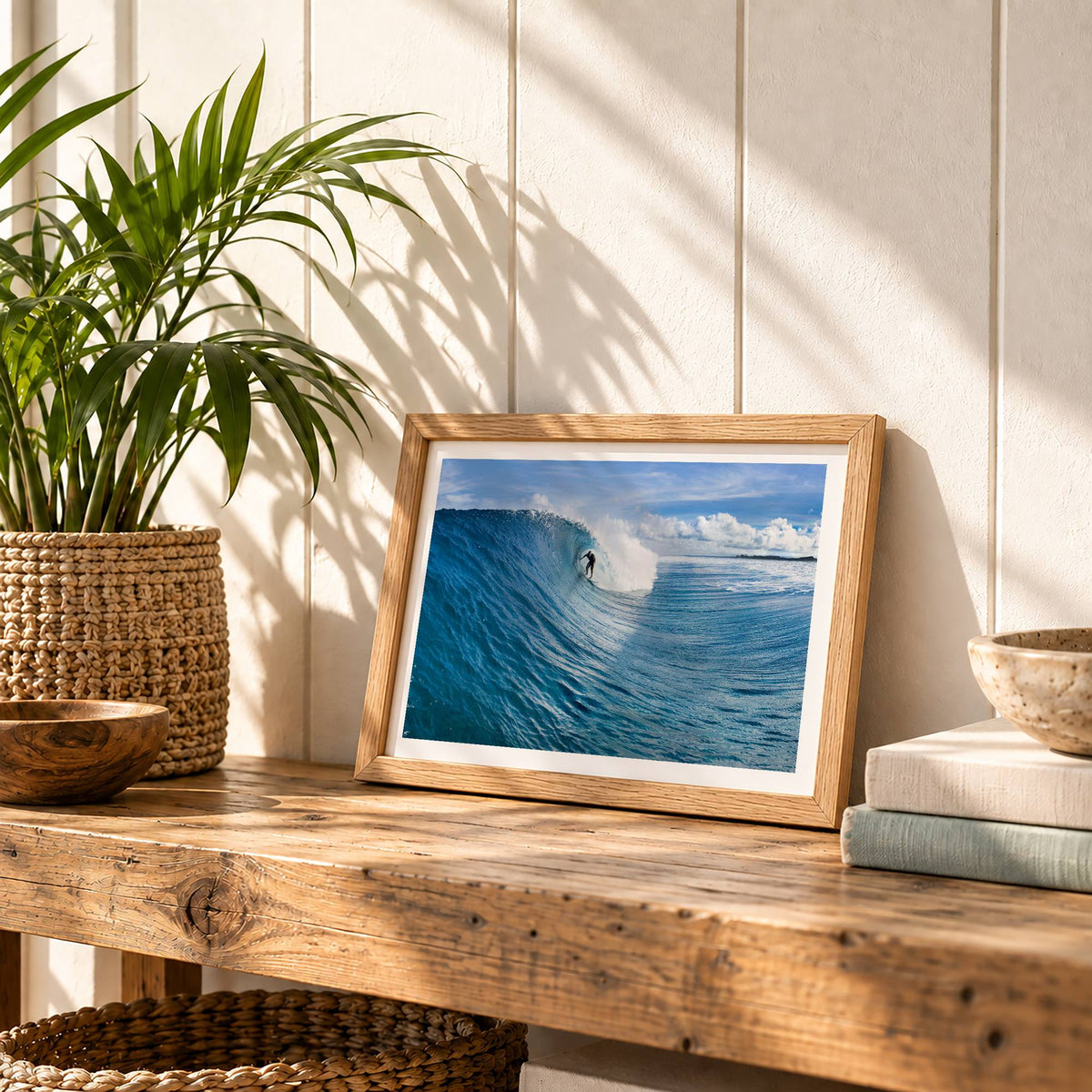 Small Blue Sling surf photography print with a white border by Sean Davey in a small frame on a wooden bench with plants