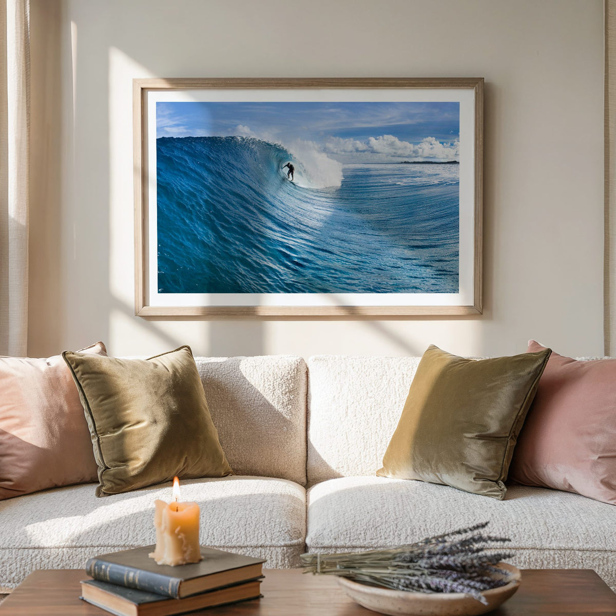 Blue Sling surf photography print with a white border by Sean Davey framed above a sofa with cushions