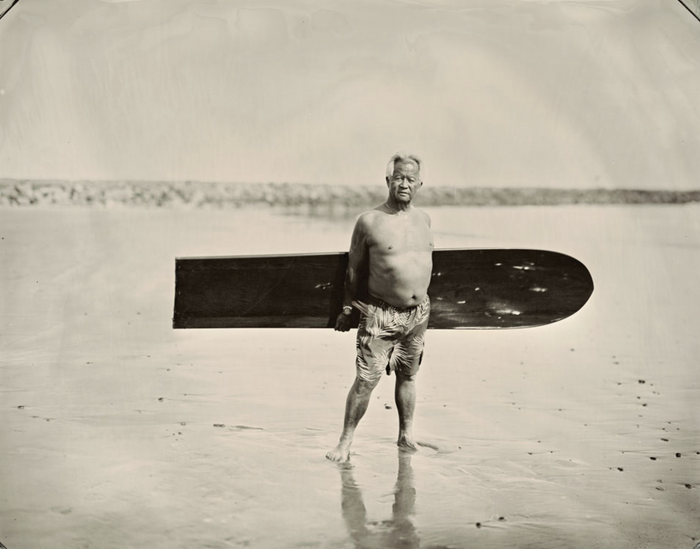 Surfer with a wooden surfboard, tintype portrait by Joni Sternbach