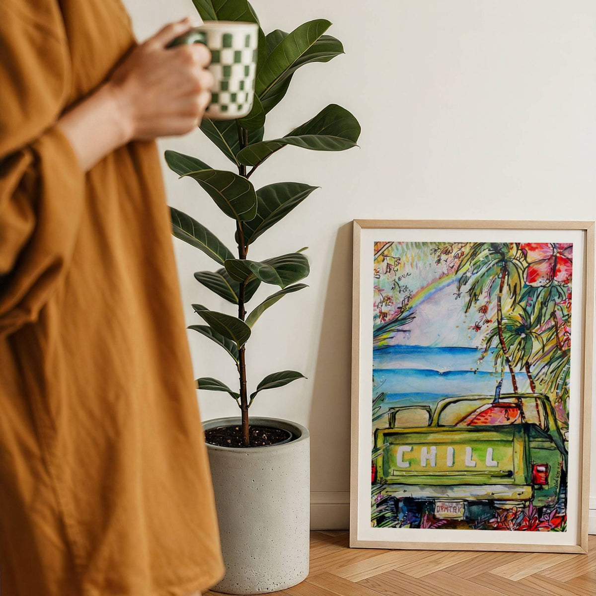 License To Chill watercolour surf art print by Rebekah Steen framed on the floor beside a coffee