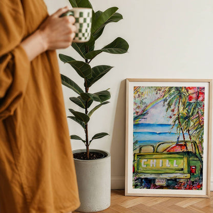 License To Chill watercolour surf art print by Rebekah Steen framed on the floor beside a coffee