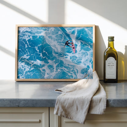 Marble Carve surf photography print by Sean Davey framed and leaning on a kitchen counter beside olive oil