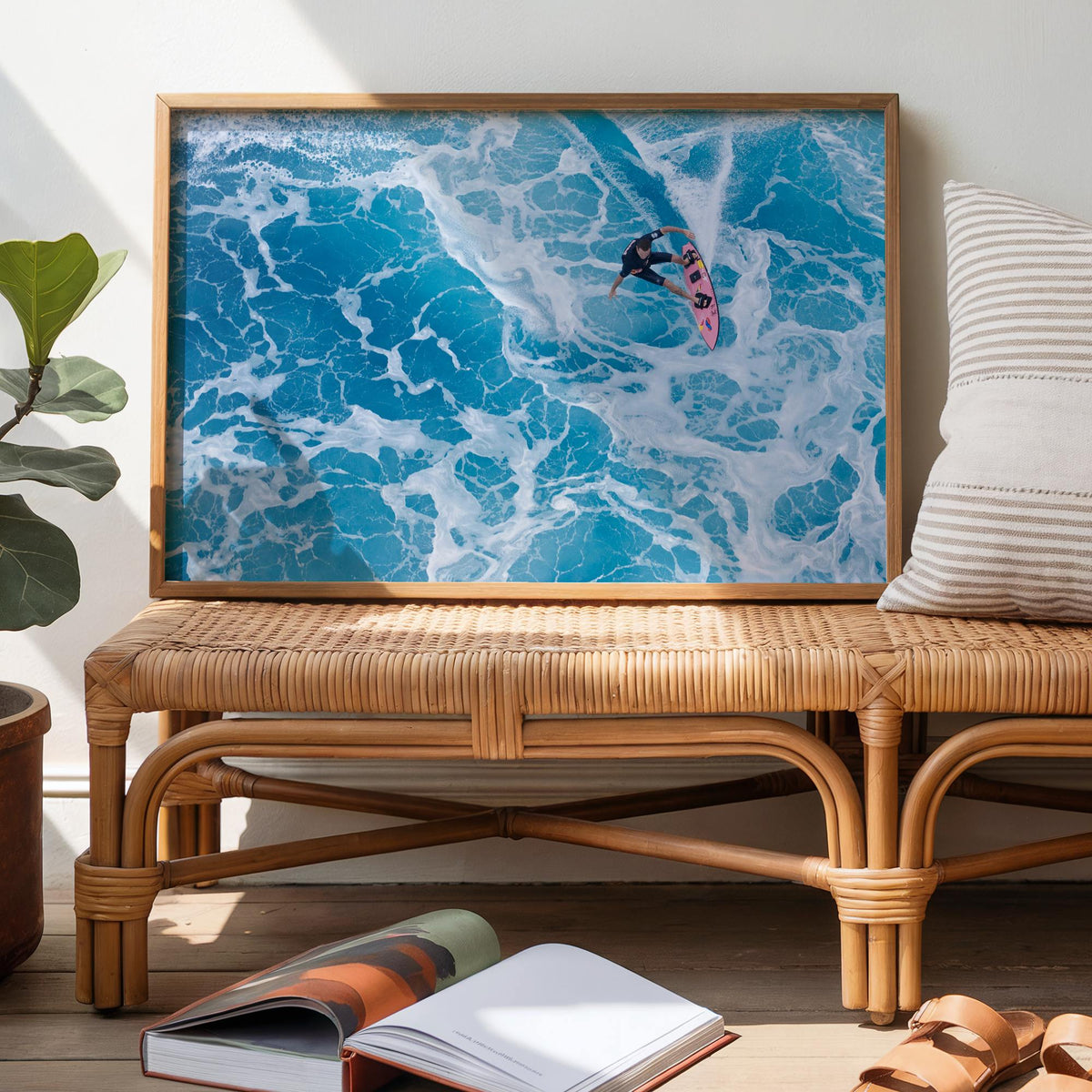 Marble Carve surf photography print by Sean Davey framed and leaning on a rattan bench