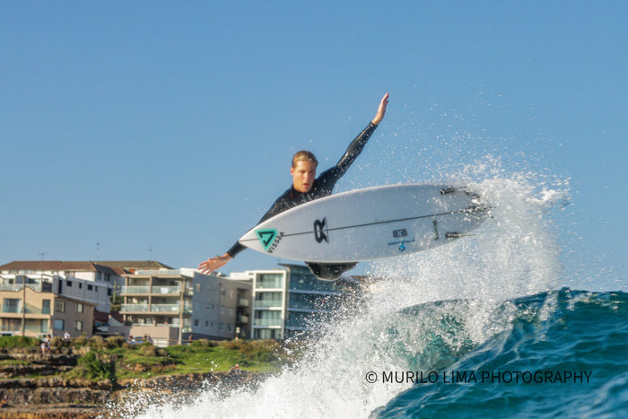Surfer launching an air above the lip, photographed by Murilo Lima