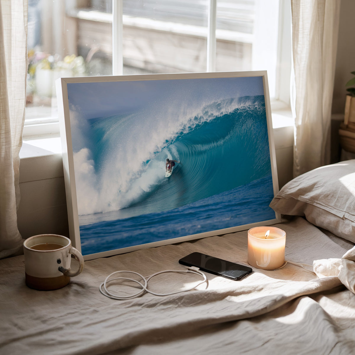 Perfection surf photography print by Sean Davey framed on a bed by a sunny window