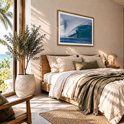 Perfection surf photography print by Sean Davey framed above a bed beside a sunny window