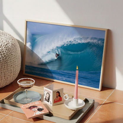Perfection surf photography print by Sean Davey framed on a tiled floor beside a candle