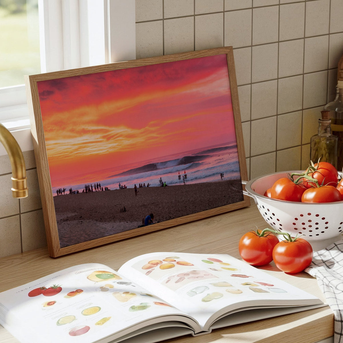 Pipeadelic surf photography print by Sean Davey framed and leaning on a kitchen counter beside tomatoes and a cookbook