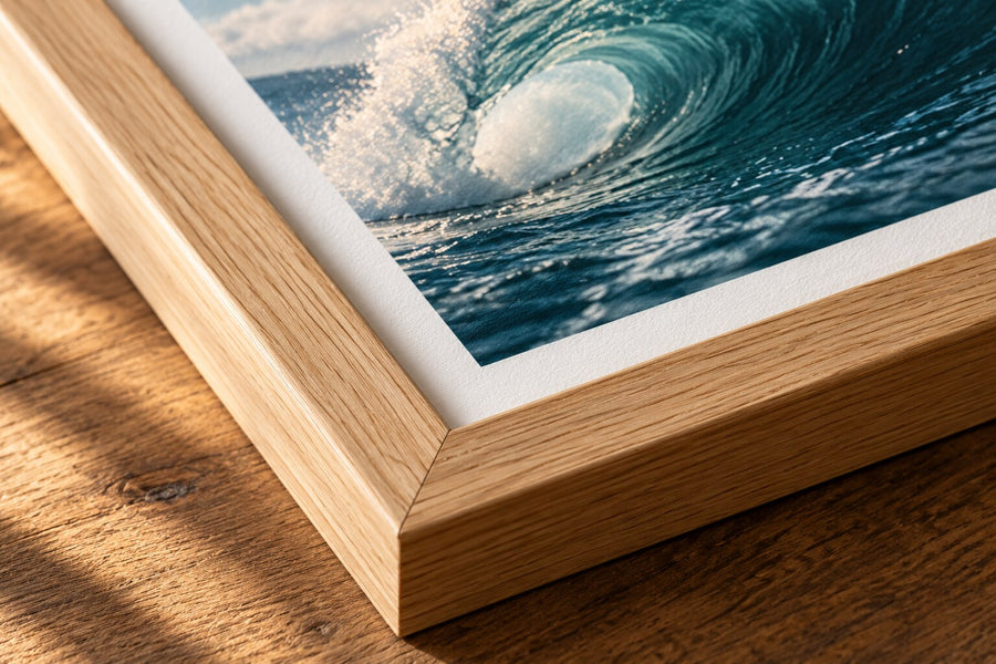 Close-up of an oak frame corner and white mount around a surf photography print