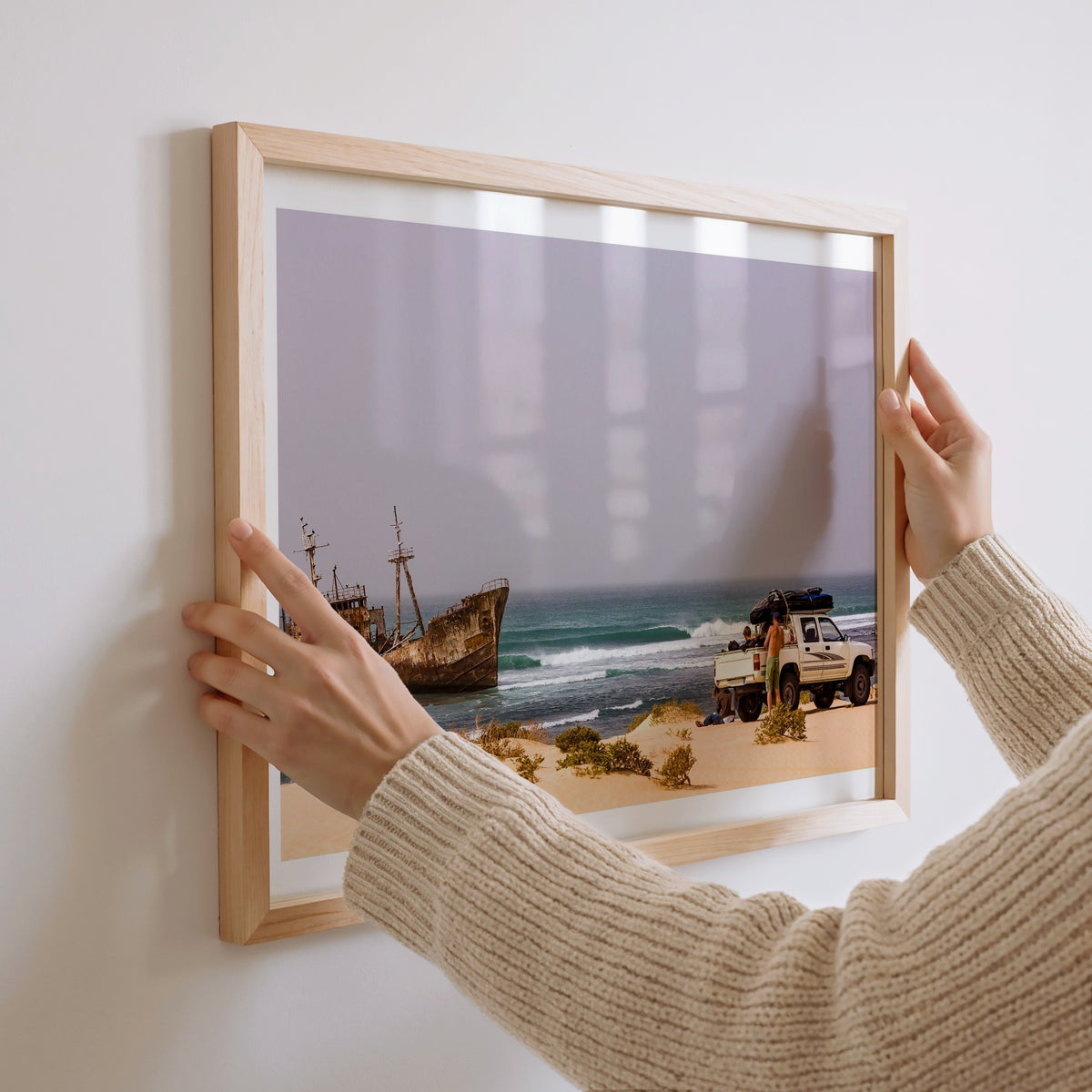 Shipwrecks surf photography print with a white border by John Seaton Callahan being hung on a wall