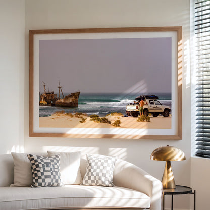 Shipwrecks surf photography print with a white border by John Seaton Callahan framed above a sofa