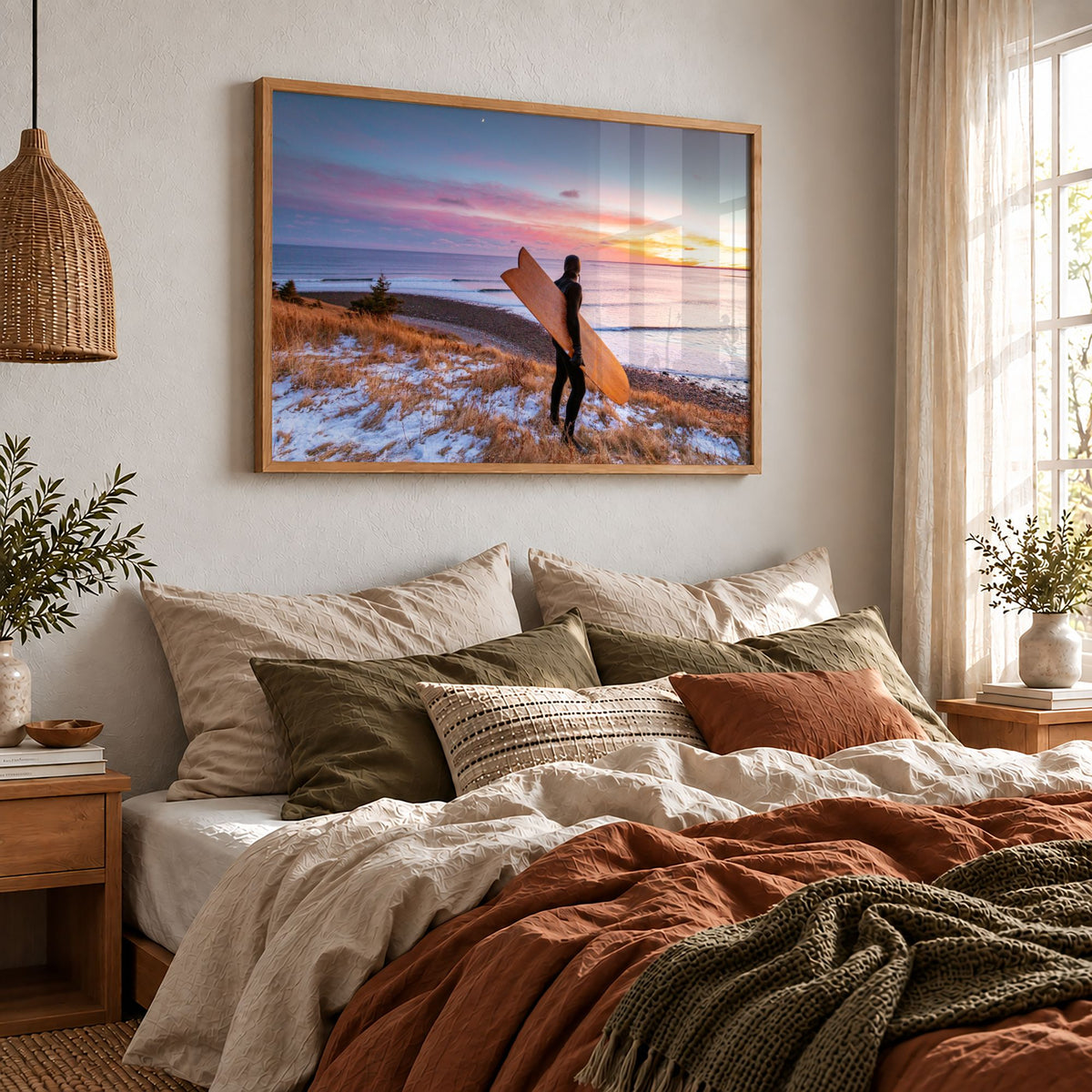 Snow and Sunrise winter surf photography print by Adam Cornick framed above a bed