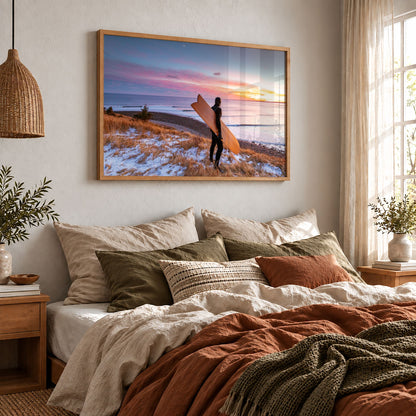 Snow and Sunrise winter surf photography print by Adam Cornick framed above a bed
