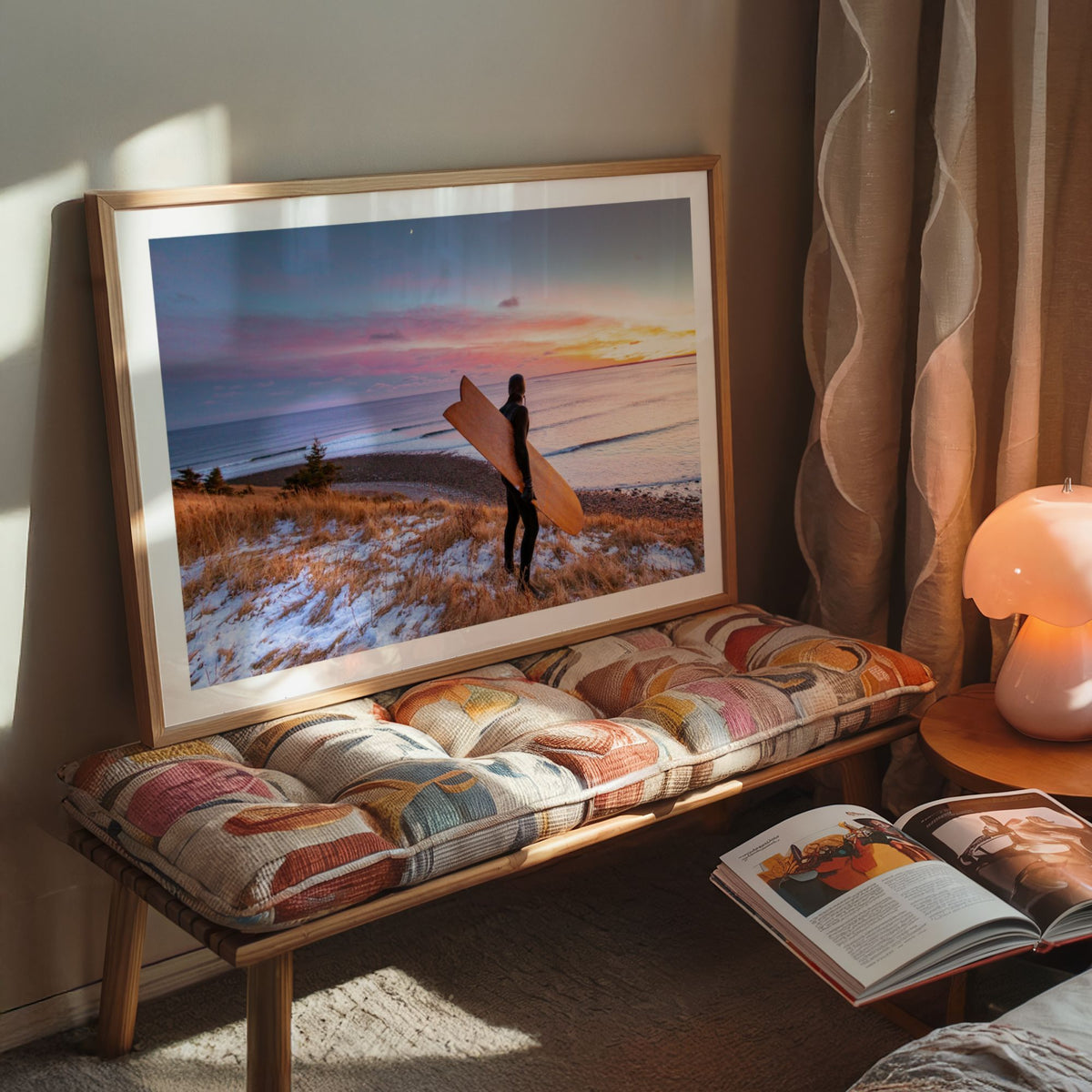 Snow and Sunrise winter surf photography print by Adam Cornick framed on a cushioned bench