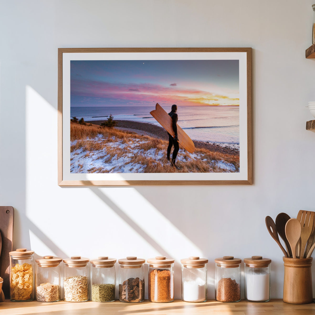 Snow and Sunrise winter surf photography print by Adam Cornick framed above a kitchen counter
