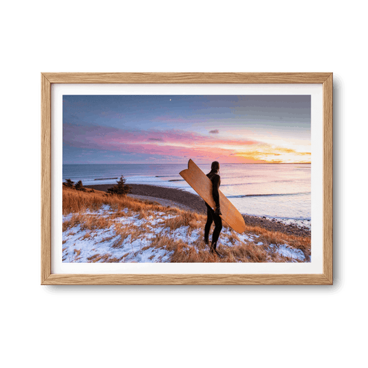 Snow and Sunrise, Lawrencetown, Nova Scotia winter surf photography print by Adam Cornick in a natural oak frame