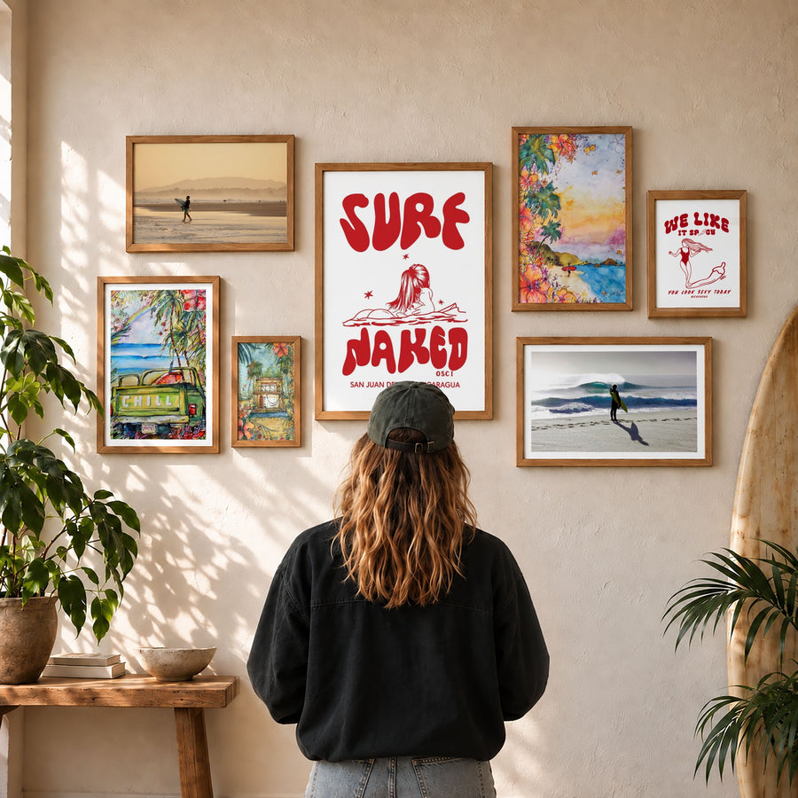 Person standing in front of a gallery wall of oak-framed prints