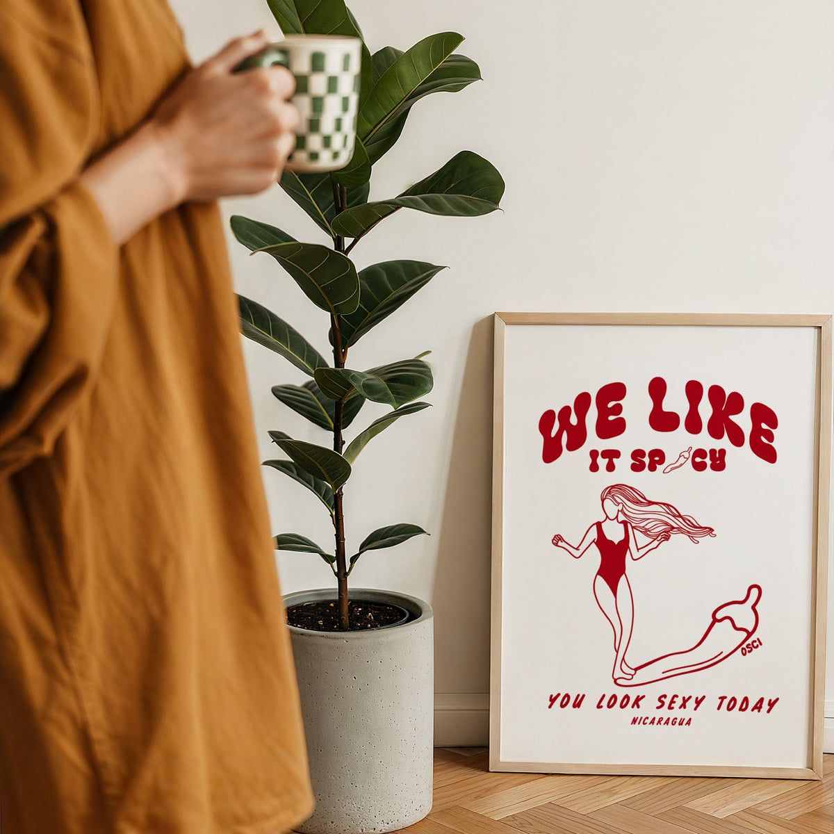We Like It Spicy surf illustration print by Osci displayed beside a coffee