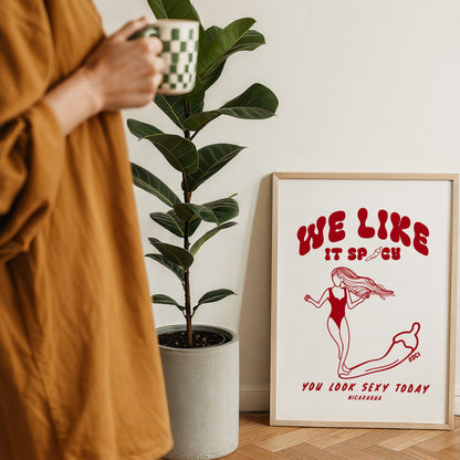 We Like It Spicy surf illustration print by Osci displayed beside a coffee